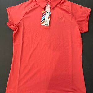 Storie Apparel Milli Polo in the Coral Crush color. Size XS